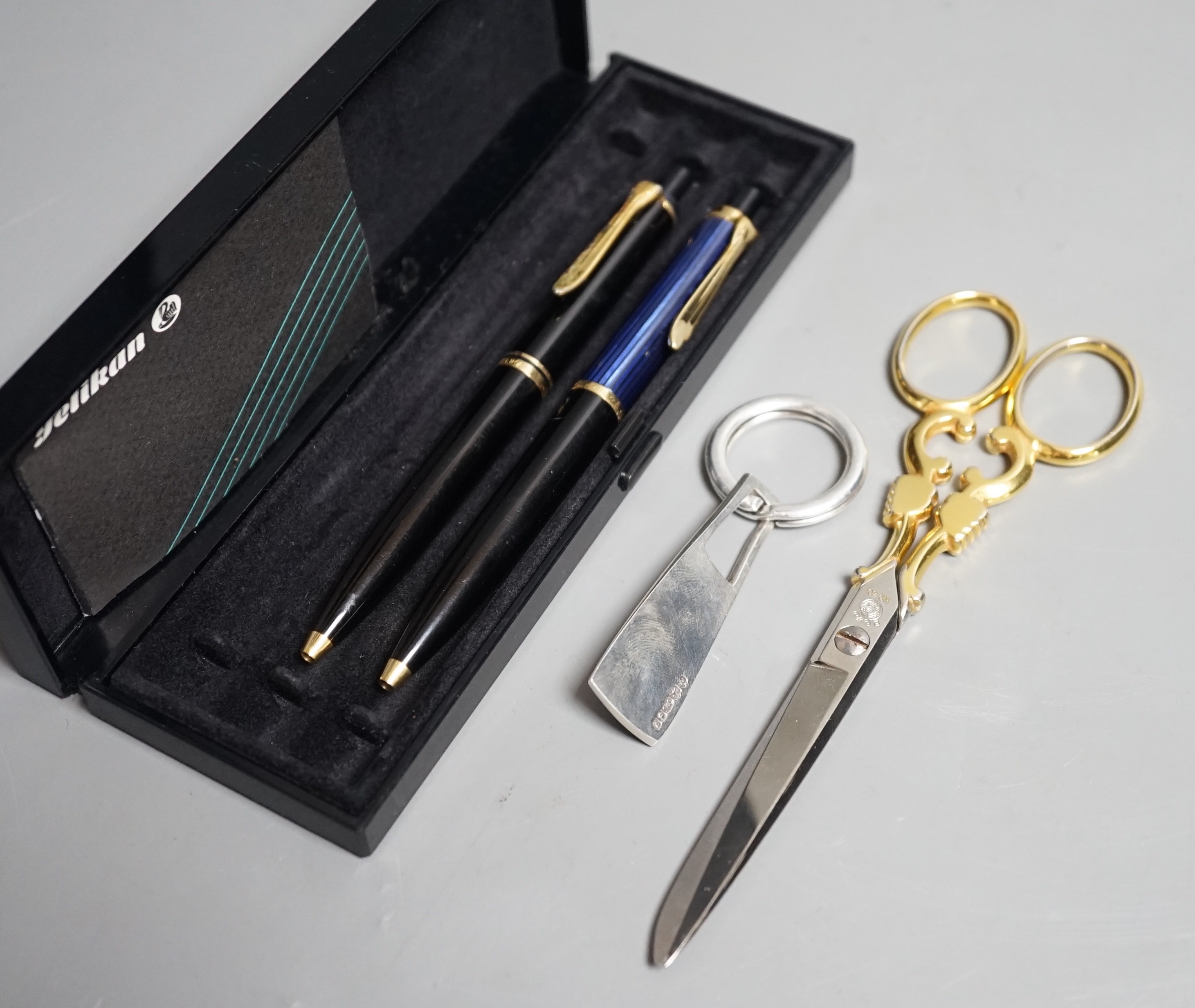 Two Pelikan ballpoint pens boxed with guarantee, 1996, a pair of Solingen scissors and a silver key ring 1999